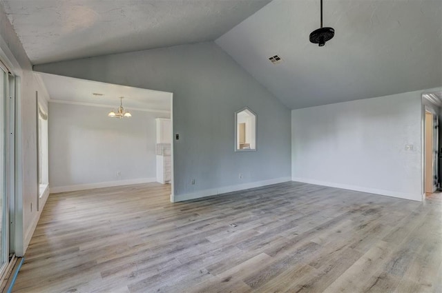 unfurnished living room with a notable chandelier, light wood-type flooring, and high vaulted ceiling