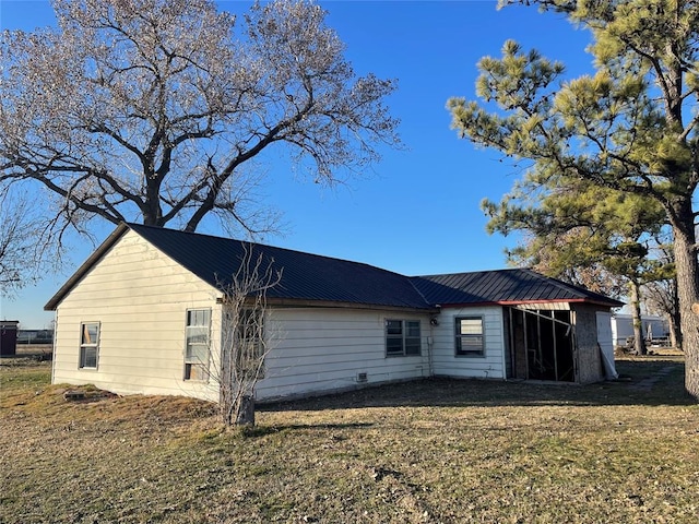 back of property with a lawn