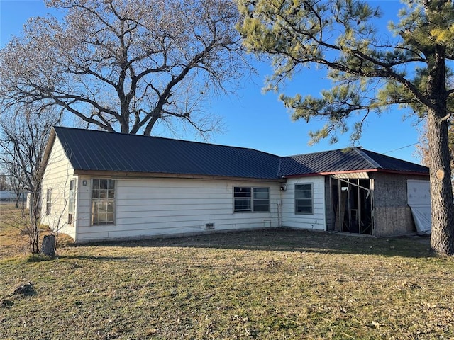 rear view of property with a lawn