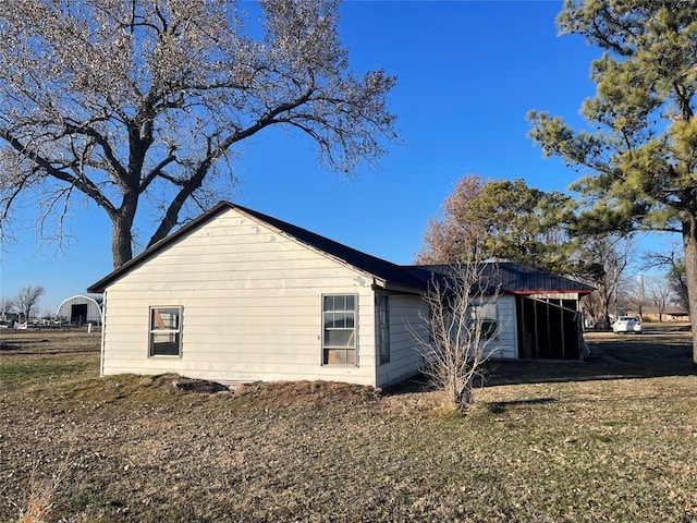 view of property exterior with a lawn