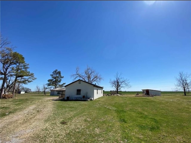 view of yard with a rural view