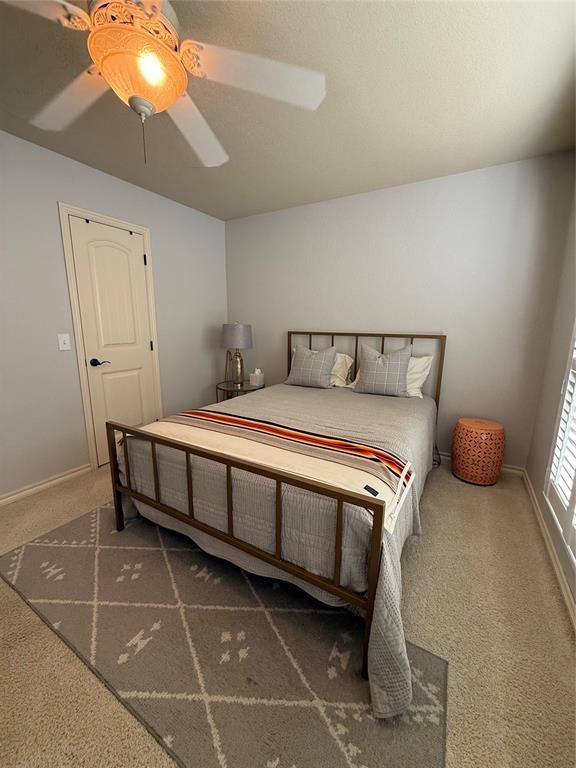 carpeted bedroom with ceiling fan