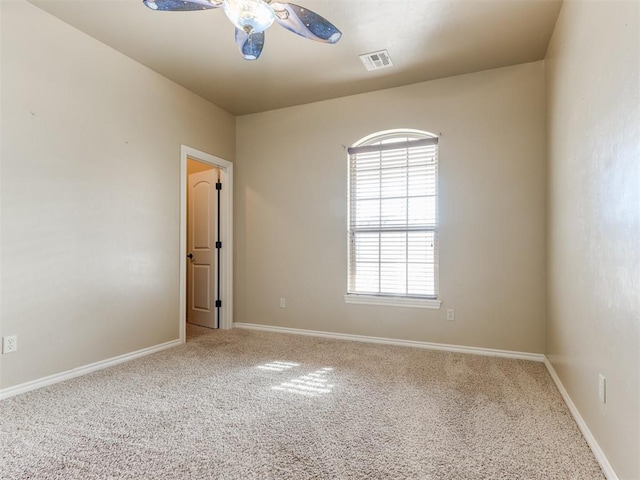 carpeted spare room with ceiling fan