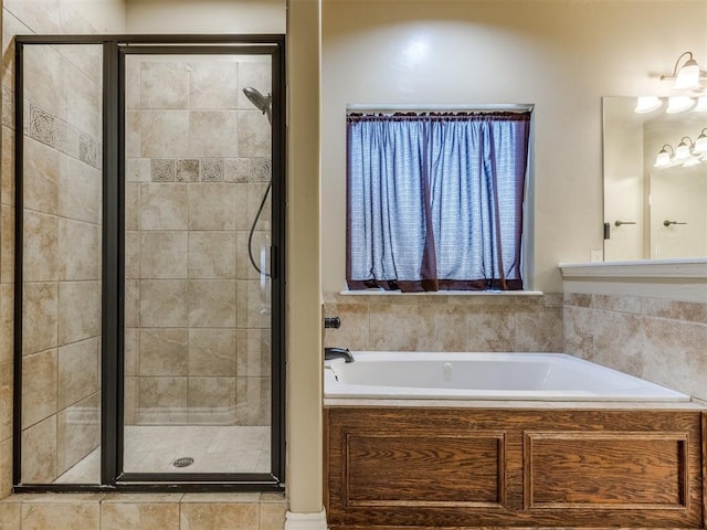 bathroom featuring separate shower and tub