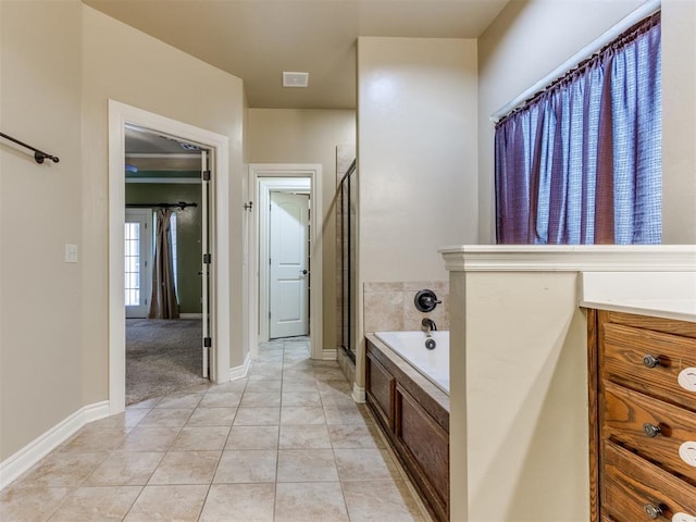 bathroom featuring tile patterned floors, separate shower and tub, and vanity