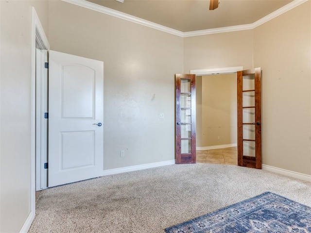 unfurnished bedroom with ornamental molding, light carpet, ceiling fan, and french doors