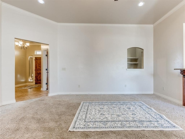 carpeted empty room with crown molding and a notable chandelier