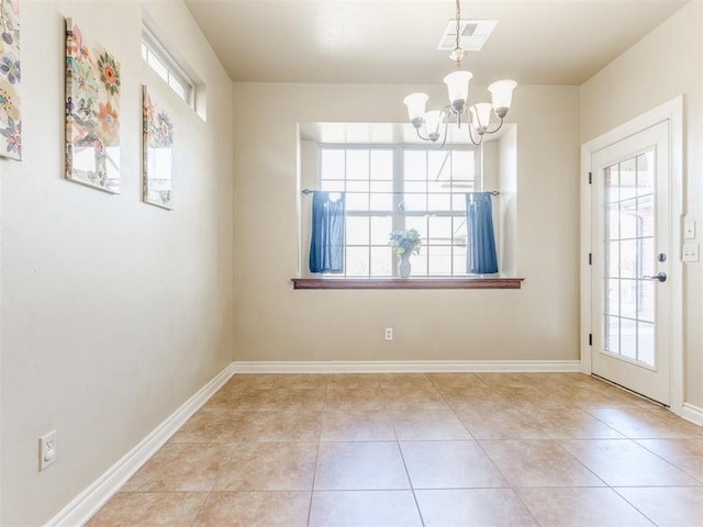 unfurnished dining area with a notable chandelier and light tile patterned floors