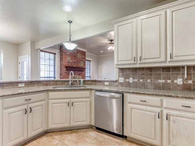 kitchen featuring light tile patterned flooring, sink, light stone counters, dishwasher, and backsplash