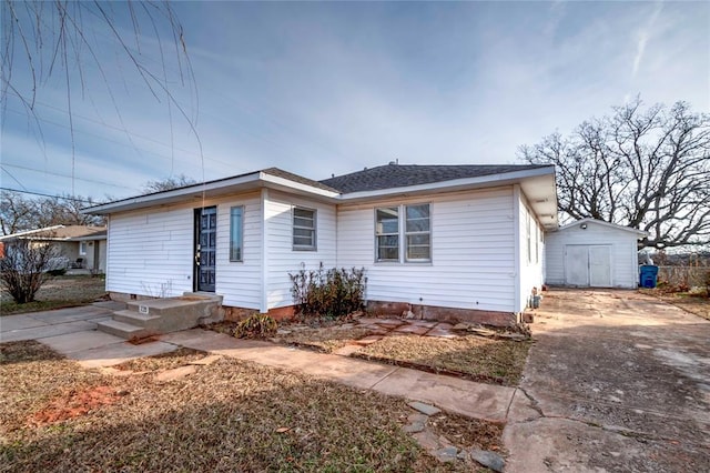 view of front of property with a shed