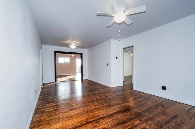 empty room with dark hardwood / wood-style floors and ceiling fan