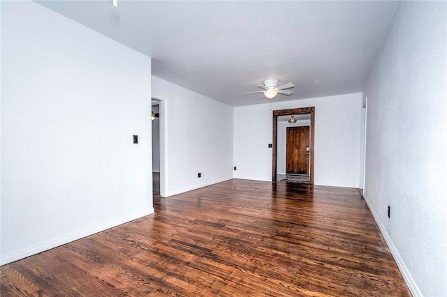 spare room with ceiling fan and dark wood-type flooring