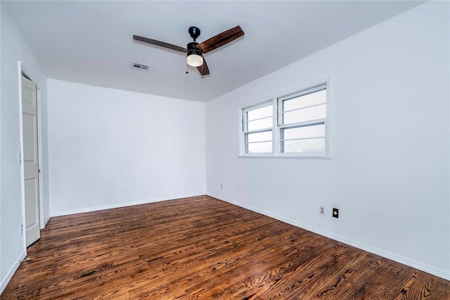 empty room with ceiling fan and dark hardwood / wood-style floors