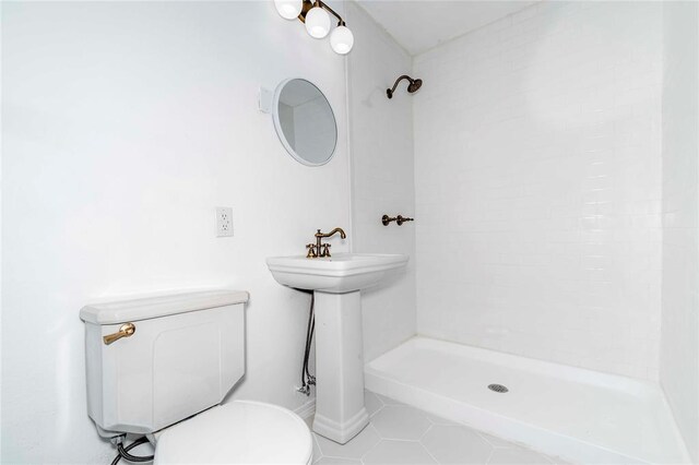 bathroom with tile patterned flooring, toilet, and walk in shower