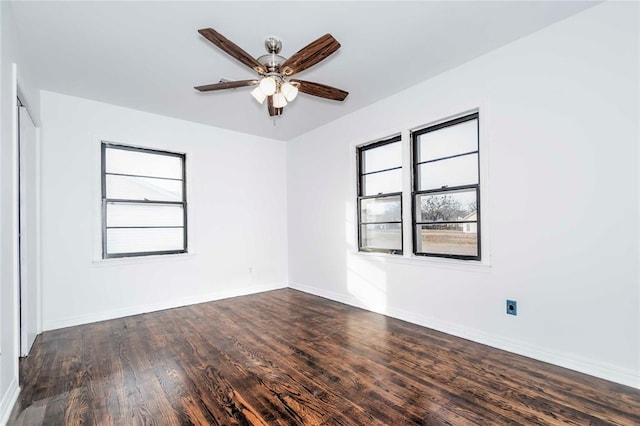 empty room with dark hardwood / wood-style flooring and ceiling fan