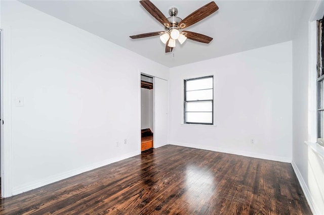 spare room with ceiling fan and dark wood-type flooring