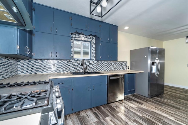 kitchen with tasteful backsplash, sink, stainless steel appliances, and blue cabinets