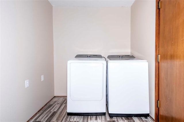 laundry area featuring independent washer and dryer and wood-type flooring