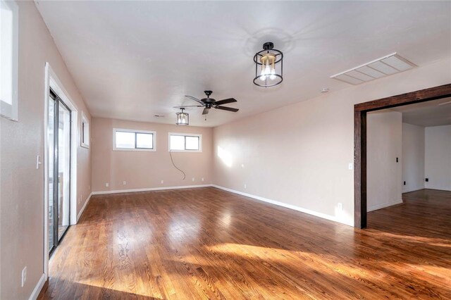 unfurnished room with ceiling fan and hardwood / wood-style flooring