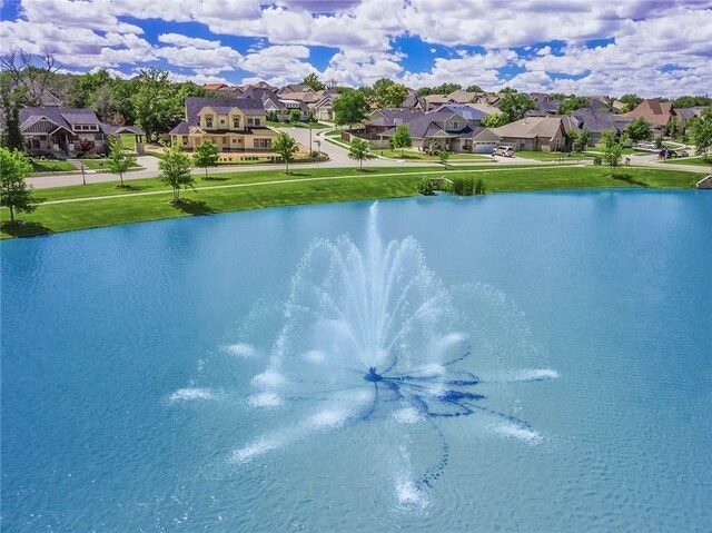 drone / aerial view with a water view and a residential view