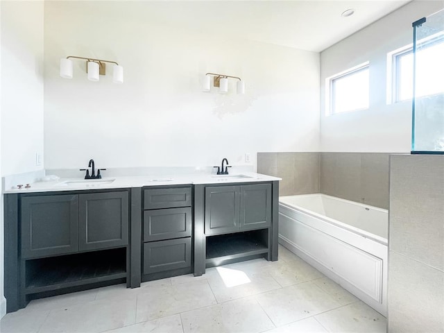 bathroom with a bath, a sink, and tile patterned floors