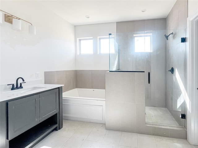 full bathroom featuring a stall shower, tile patterned floors, a bath, and vanity