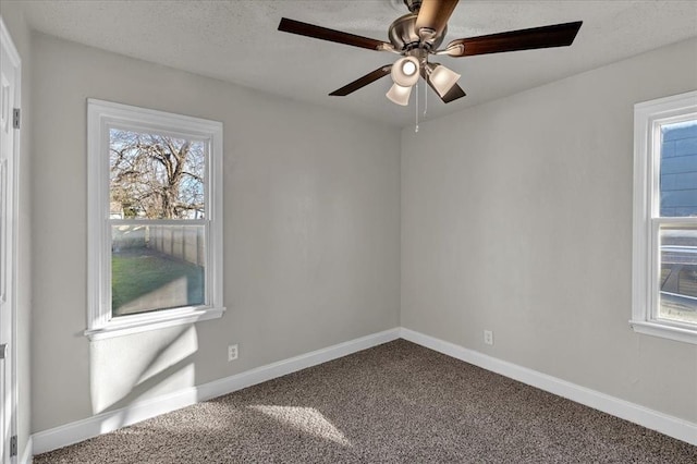 empty room with ceiling fan and carpet