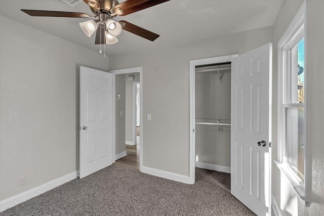 unfurnished bedroom with carpet flooring, ceiling fan, and a closet