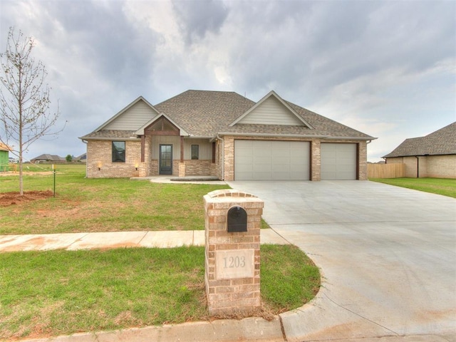 1203 Jaden Blvd, Tuttle, OK 73089 - craftsman house with an attached garage, concrete driveway, brick siding, and a shingled roof