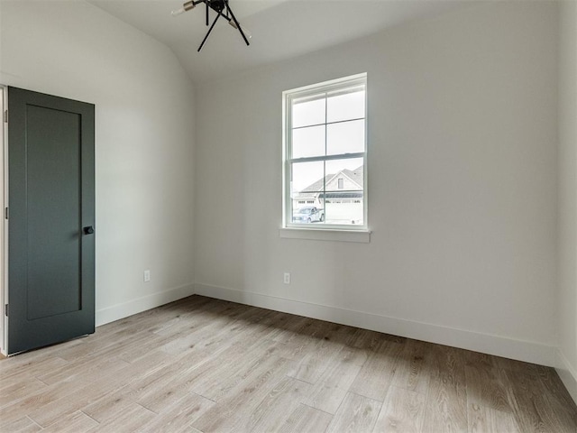 1203 Jaden Blvd, Tuttle, OK 73089 - unfurnished room with baseboards, light wood-style floors, and vaulted ceiling