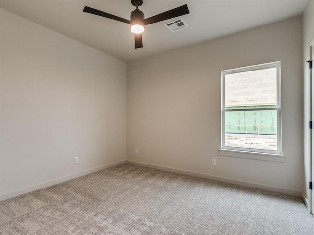 1203 Jaden Blvd, Tuttle, OK 73089 - spare room featuring light carpet, a ceiling fan, and baseboards