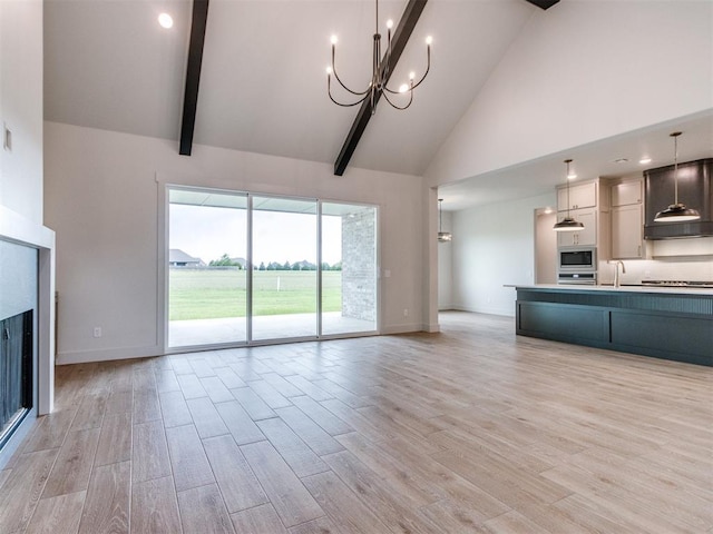 1203 Jaden Blvd, Tuttle, OK 73089 - unfurnished living room with high vaulted ceiling, baseboards, light wood-style flooring, a chandelier, and beam ceiling
