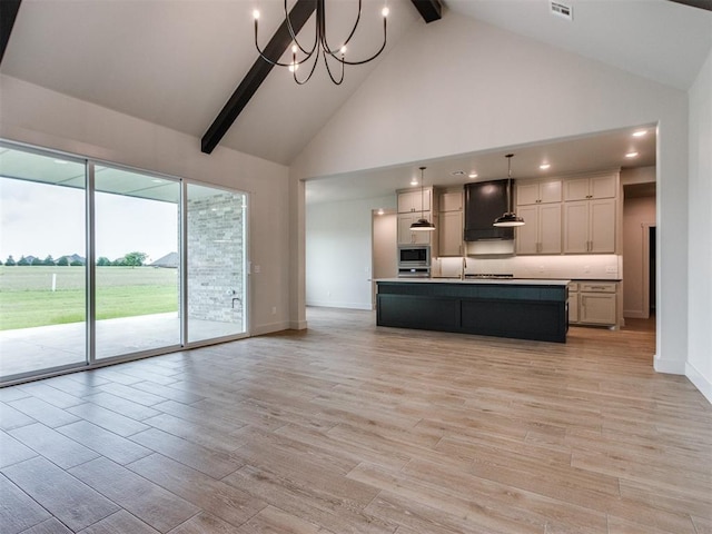 1203 Jaden Blvd, Tuttle, OK 73089 - kitchen with high vaulted ceiling, beam ceiling, stainless steel appliances, light wood-style flooring, and open floor plan