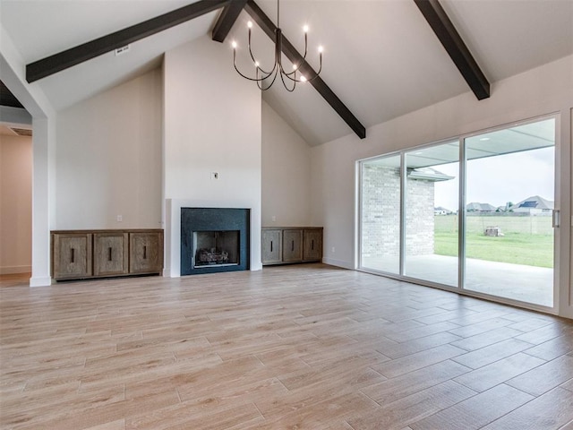 1203 Jaden Blvd, Tuttle, OK 73089 - unfurnished living room featuring beam ceiling, high vaulted ceiling, baseboards, light wood-style flooring, and a chandelier