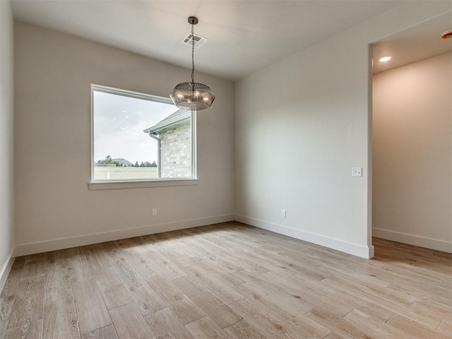 1203 Jaden Blvd, Tuttle, OK 73089 - empty room with light wood-style floors, a chandelier, baseboards, and recessed lighting