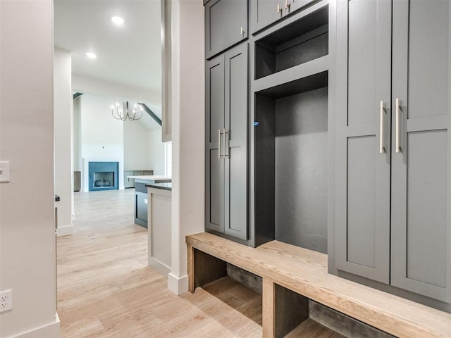 1203 Jaden Blvd, Tuttle, OK 73089 - mudroom with light wood-style floors, baseboards, recessed lighting, a chandelier, and a fireplace