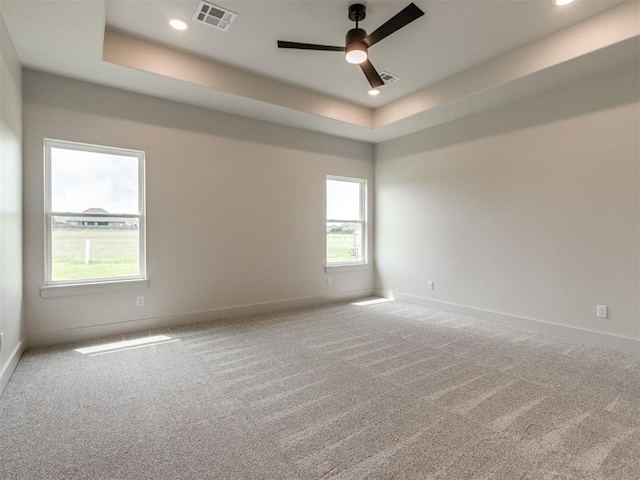 1203 Jaden Blvd, Tuttle, OK 73089 - unfurnished room with a raised ceiling, baseboards, carpet, and recessed lighting