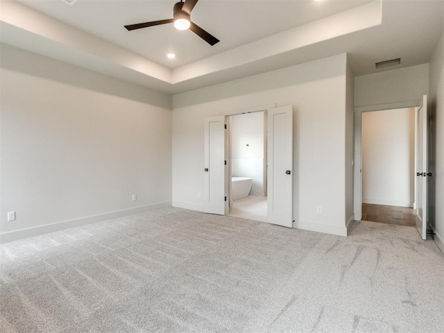1203 Jaden Blvd, Tuttle, OK 73089 - unfurnished bedroom with carpet, baseboards, a raised ceiling, ensuite bath, and recessed lighting