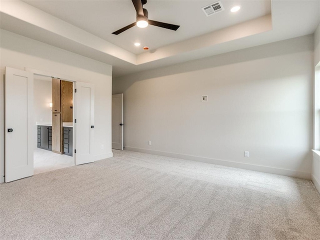 1203 Jaden Blvd, Tuttle, OK 73089 - spare room featuring a ceiling fan, light carpet, a raised ceiling, baseboards, and recessed lighting