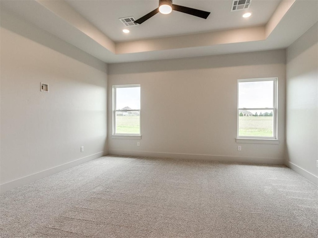 1203 Jaden Blvd, Tuttle, OK 73089 - spare room with a ceiling fan, a raised ceiling, light carpet, baseboards, and recessed lighting