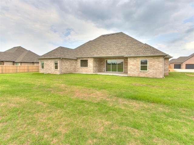 1203 Jaden Blvd, Tuttle, OK 73089 - back of property featuring brick siding and a shingled roof