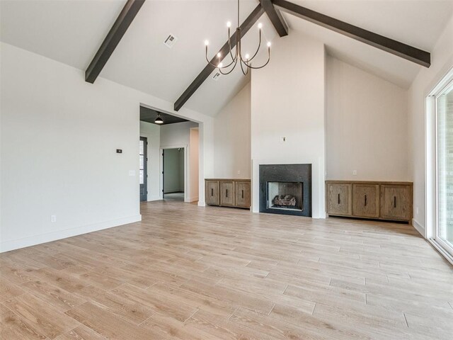 1203 Jaden Blvd, Tuttle, OK 73089 - unfurnished living room featuring beamed ceiling, high vaulted ceiling, light wood-type flooring, a chandelier, and a fireplace