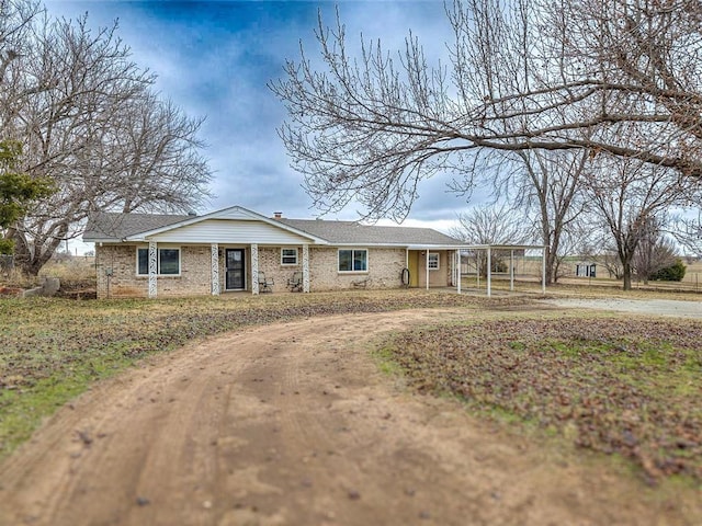 ranch-style home featuring a carport