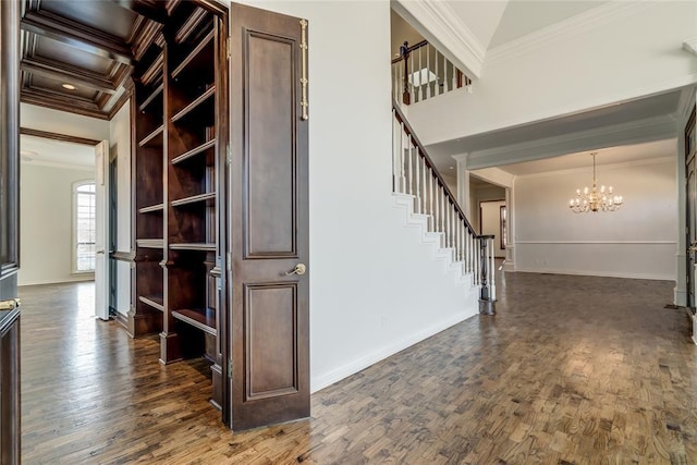 stairs with hardwood / wood-style floors, an inviting chandelier, and ornamental molding