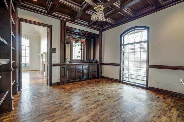 interior space featuring beamed ceiling, wooden ceiling, crown molding, and coffered ceiling