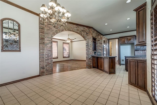 kitchen featuring crown molding, dark brown cabinets, light tile patterned floors, and ceiling fan with notable chandelier