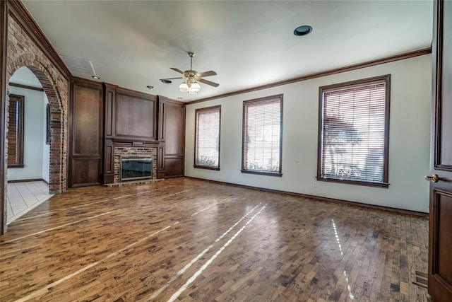 unfurnished living room with dark hardwood / wood-style flooring, ceiling fan, and ornamental molding