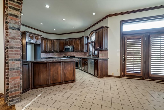 kitchen featuring backsplash, dark brown cabinets, light tile patterned floors, and stainless steel appliances