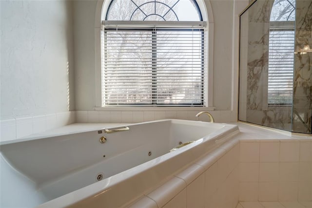 bathroom featuring a relaxing tiled tub