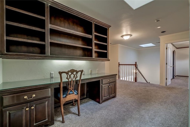 home office featuring light carpet, built in desk, and crown molding